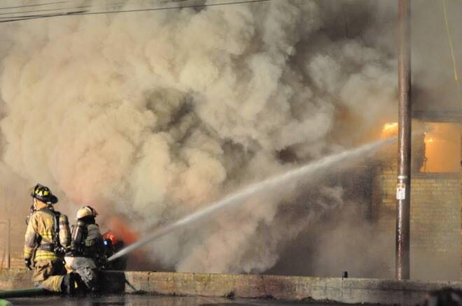 Rochester firefighters attacking a structure fire